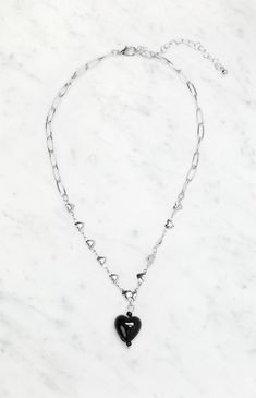 The LA Hearts Black Heart Chain Necklace is a sleek and versatile piece, perfect for adding a touch of edge to any outfit. The silver hearts and black drop charm create a chic contrast, while the adjustable closure ensures a comfortable fit for all.


	Chain link design
	Silver heart accents
	Black drop charm
	Adjustable lobster clasp closure Black Heart Pendant Chain Jewelry, Black Heart Pendant Edgy Jewelry, Black Heart-shaped Chain Jewelry, Edgy Black Jewelry With Heart Charm, Edgy Black Heart Pendant Jewelry, Black Chain Necklace For Valentine's Day, Black Stainless Steel Heart Pendant Necklace, Black Valentine's Day Necklace, Valentine's Day Black Chain Necklace