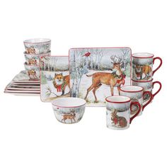 a set of five cups and saucers with deer designs on the front, along with matching dishes