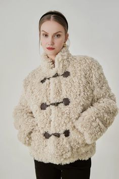 Embrace the cold with the Fluffy Stand Collar Teddy Jacket. A blend of chic style and comfort, this jacket comes with a unique stand collar that provides an enhanced sense of warmth, ensuring a snug feel during chilly days. Its length falls right at the hip, emphasizing a flattering silhouette. Beige Winter Outerwear With Buttons, Cozy Outerwear With Button Cuffs, Beige Buttoned Outerwear For Cold Weather, Beige Outerwear With Button Closure For Cold Weather, Beige Buttoned Outerwear For Winter, Winter Pea Coat With Stand Collar And Button Closure, Cozy Beige Outerwear With Button Closure, Cream Double-breasted Outerwear With Buttons, Cream Double-breasted Outerwear For Winter