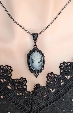 Embrace timeless elegance with this stunning Gothic Cameo Necklace featuring a blue tones vintage lady portrait in a beautifully detailed black setting. Adorned with intricate details and set against a backdrop of elegant black enamel, this pendant exudes timeless sophistication. The contrasting blue tones against the inky black enhance the allure of the cameo, evoking a sense of mystery and elegance. Crafted with meticulous attention to detail, this pendant is suspended from a matching black ch Lady Cameo Necklace, Lady Portrait, Portrait Necklace, Dark Vintage, Cameo Earrings, Vintage Inspired Jewelry, Gothic Necklace, Vintage Lady, Cameo Necklace