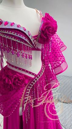 a pink belly dance costume with flowers on it