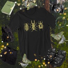 Three Beetles Tshirt * Goblincore Cottagecore Fairycore Goth Grunge Aesthetic * Witchy Nature inspired Alt fashion * Bugs Insect Shirt *  ALL SIZES ARE UNISEX (despite of it saying "Men's" in the size options)  *About Fern and Fly* Our designs are unique, created, edited or drawn by us and are all inspired by all things nature, magic, art and folklore! *Material* 100% cotton. Pre-shrunk for extra durability. Shoulder-to-shoulder taping. Quarter-turned to avoid crease down the center. *Print* On Black Goblincore Top With Graphic Print, Goblincore Streetwear Crew Neck Tops, Goblincore Crew Neck Streetwear Tops, Black Fairy Grunge T-shirt For Streetwear, Goblincore Crew Neck Tops For Streetwear, Halloween Fairy Grunge Tops, Black Goblincore Tops For Halloween, Goblincore Cotton Streetwear Tops, Black Fairycore Crew Neck Top