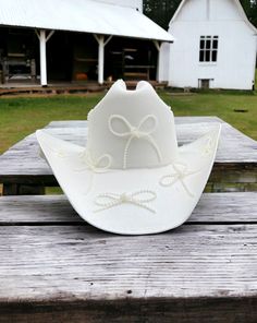 Baby features the daintiest of pearl bows adorning the a clean white hard canvas cowboy hat. Proudly American Made. Our hats are manufactured in Mexico and details added by hand in Los Angeles, CA using the highest quality materials. Sizing S/M 19in-22.75in | 48cm-57.5cm L/XL 19.5in-23.25in | 49.5cm-59cm *Please allow up to 2 weeks for production and shipping. Garden Party Bridal Shower, Parisian Summer, Bridesmaid Duties, Baby L, Bridal Fabric, Bach Party, Welcome To The Party, Cowgirl Hats, Hand Painted Rocks