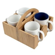 a wooden tray with four cups and two spoons in it on a white background