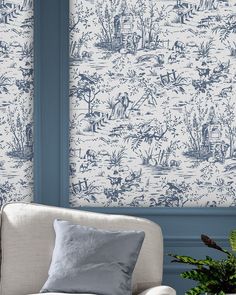 a living room with blue and white wallpaper, two couches and a potted plant