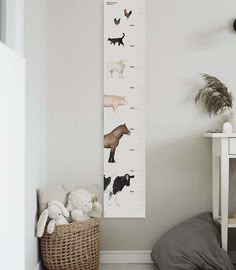 a growth chart with animals on it in a child's room next to a bed