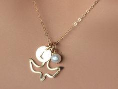 "14k Gold Fill Initial Freshwater Pearl Dove Necklace. Gold Dove Necklace perfect gift for best friend , Sister, Daughter , Mother ,Mother of Bridesmaid , Mother of Groom and Bridesmaid. ★★It make of... -9mm 14k Gold Fill Initial Disc, -20mm 14k Gold Fill Open Dove charm, -4-6 mm Freshwater Pearl and -14k Gold Fill Chain chain with claw. -Come up with small ribbon gift Box. MORE BIRDS https://www.etsy.com/shop/rainbowearring/search?search_query=BIRD+&order=date_desc&view_type=gallery&amp Elegant Bird Design Jewelry Gift, Elegant Bird Design Jewelry For Gift, Gold Jewelry With Bird Design For Wedding, Gold Wedding Jewelry With Bird Design, White Bird-shaped Jewelry Gift, Gold Necklace With Bird Design As Gift, Gold Necklace With Bird Design For Gift, Dove Flying, Dove Necklace