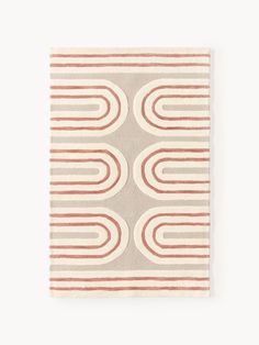 a beige and red rug with circles on the bottom, in front of a white background