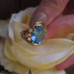 Vintage 14KT Yellow Gold Ring is gorgeous. Two Plus CT Large Oval Blue Topaz Ring with Three Nice Size Genuine Diamonds on One Side of Band. The Gold Band has a Double Swirl on One Side and this Ring is a Size 5. Ring is Hallmarked inside of Band 14K with Maker's Mark. Three Oval Diamonds and they are a nice size. In excellent vintage condition. FREE SHIPPING. Where can you find a Genuine Diamond 14KT Gold Ring with a Lovely large Blue Topaz - Perfect Holiday Gift SANTA CLAUS IS COMING TO TOWN - Turquoise Sapphire Gemstone Ring For Anniversary, Unique Formal Topaz Ring, Anniversary Turquoise Topaz Ring With Gemstone Accents, Turquoise Topaz Ring With Gemstone Accents For Anniversary, Oval Blue Topaz Gemstone For Anniversaries, Oval Blue Topaz Gemstone For Anniversary, Heirloom Topaz Ring With Gemstone Accents As Gift, Anniversary Topaz Gemstones Fine Jewelry, Unique Topaz Gemstone Ring For Anniversary