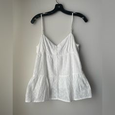 Lush Off White Empire Waist Eyelet Sleeveless V-Neckline Top Size Medium. Lined, Lightweight, Adjustable Straps, Pullover Style. Self: 100% Cotton Lining: 100% Rayon. Hand Washable. Approximate Measurements Flat: See Photos. Summer V-neck Camisole For Vacation, Summer Cotton V-neck Vest, Summer V-neck Tank Top For Day Out, Cotton V-neck Tank Top For Vacation, Summer V-neck Vest Top, White V-neck Summer Vest, Summer White V-neck Vest, White V-neck Camisole For Vacation, Chic V-neck Beach Vest