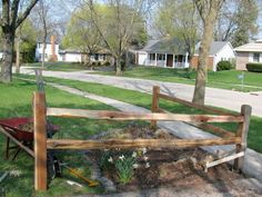 a wooden fence sitting in the middle of a yard