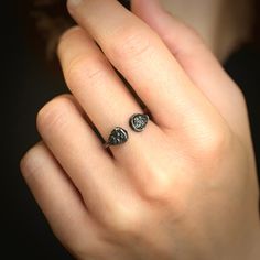 a woman's hand with two rings on it and one is holding the other