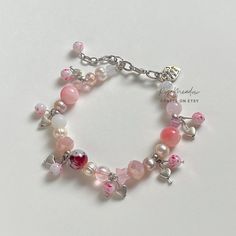 "Handmade Dreamy Bracelet ✿ Made with glass crystal beads, Quartz, rose Quartz, freshwater pearls, glass beads, and metal accents ✿ Colors: Silver, a multitude of pinks, blush pink, icy pink, pearlescent pink, milky white. maroon, iridescent clear, pearlescent white, and iridescent clear ✿ The bracelet has an additional 1-1.5\" of extension chain" Elegant Pink Beaded Bracelets With Heart Beads, Pink Beaded Crystal Bracelet For Valentine's Day, Pink Pearl Beaded Bracelets For Jewelry Making, Pink Pearl Charm Bracelet, Feminine Pink Pearl Bracelets, Dreamy Bracelet, Icy Pink, Gelang Manik-manik, Love Me More