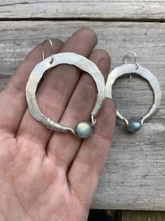 "1.75\" sterling silver hand-forged hoops wrapped with a flashy labradorite. Oxidized silver or plain silver finish. You choose at checkout ! 2.25\" drop from hypoallergenic niobium earwires. Handmade in NY" Artisan Handmade Silver Hoop Earrings, Artisan Sterling Silver Hoop Earrings, Everyday Silver Hand Wrapped Jewelry, Everyday Hand Wrapped Silver Jewelry, Artisan Hammered Dangle Hoop Earrings, Artisan Small Hoop Sterling Silver Earrings, Handmade Sterling Silver Hoop Wrap Earrings, Handmade Unique Sterling Silver Hoop Earrings, Minimalist Freeform Sterling Silver Jewelry