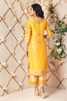 A Festive Jacquard Silk net ensemble in beautiful yellow hue featuring floral embroidery in multi colors, embellished in gota along with dabka, sequins, stones and pearls.Gota embellished hand block printed borders to enhance look. This stunning kurta is paired with jamawar culottes with gota embellished border and Shimmer net dupatta embellished with dhanak, sequins, block printed border and gota florals, tassels at back, making it a perfect choice for Mehendi, mayun and other wedding festiviti Designer Outfit, Boutique Suits, Master Card, Net Dupatta, Pakistani Designers, Full Sleeve, Floral Embroidery, Block Print, Custom Sizing