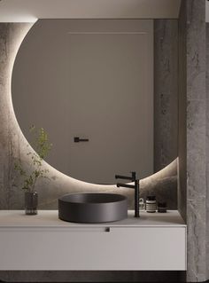 a bathroom with a circular mirror above the sink