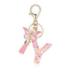 a keychain with a butterfly and letter y on the front, in pink