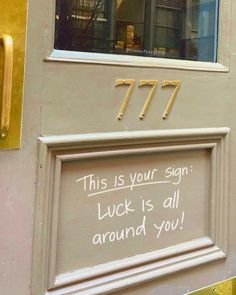 this is your sign luck is all around you written on the door to an apartment building