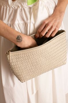 Woven leather pouche for all of your traveling needs. Inner pocket and zip closure Doubles as a clutch. Measures 12" x 7" x 4". Fabric is 100% leather. Beige Leather Clutch With Zipper Closure, Versatile Soft Leather Clutch Pouch, Beige Soft Leather Pouch Clutch, Rectangular Textured Leather Clutch For Travel, Rectangular Soft Leather Clutch For On-the-go, Textured Leather Rectangular Travel Pouch, Textured Leather Travel Pouch, Rectangular Shape, On-the-go Zipper Clutch Pouch, Leather Clutch Pouch With Zipper Pocket