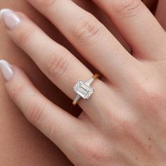 a woman's hand with a diamond ring on it