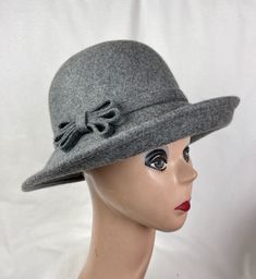 "This gray 1920's inspired cloche hat has a felt bow and band and a 1.5\" turned-up slanted brim in the front. The hat will fit up to 22 7/8 inch head size with a sizing cord in the inside band. NOTE: Please check the head size before purchase, I am happy to answer any questions you may have. There will be a 20% restocking fee for all returned hats." Retro Wide Brim Cloche Hat For Winter, Classic Brimmed Hat With Bow, Classic Short Brim Hat With Bow, Classic Adjustable Hat With Bow, Retro Winter Cloche Hat With Short Brim, Fitted Brimmed Hat With Bow, Retro Cloche Felt Hat For Winter, Classic Felt Cloche Hat, Fitted Hat With Bow And Curved Brim