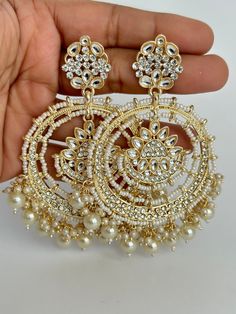 Gold Bollywood Stone Kundan Earrings Indian long Earrings/pearl Earring/Pakistani Earrings/Statement Earrings/Long chandelier/bridal earrings Length 3.5 inches  Width 2.5 inches Arrives in a gift box Color, shades, and texture displayed may slightly vary from the actual product due to digital image limitations. We request that you to consider these minor variations. Please expect the possibility of some slight imperfections when buying handmade jewelry. If you have any questions, please contact us. Chaandbali Kundan, Punjabi Jewellery, Pakistani Earrings, Stained Glass Earrings, Promise Jewelry, Indian Accessories, Bridal Earring, Long Chandelier, Bridal Earrings Chandelier