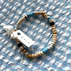 a wooden beaded bracelet with a tag on it