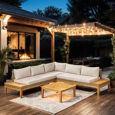 an outdoor living area is lit up at night