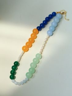 This exquisite necklace combines the timeless elegance of pearls with the playful charm of multi-colored beads to create a necklace that exudes a lighthearted vibe. Each pearl and bead forms a harmonious blend of color and texture, perfect for adding a refreshing touch to your summer wardrobe. Whether you're lounging by the beach or attending a garden party, this necklace is sure to enhance your ensemble with its versatile and lively aesthetic. Metal: 18K Recycled Gold Plated On Brass Pearl: Fre Lively Aesthetic, Edison Pearls, Gemstone Beaded Necklace, By The Beach, Tiger Eye Stone, Pearl Gemstone, Green Necklace, Recycled Gold, Stone Necklace