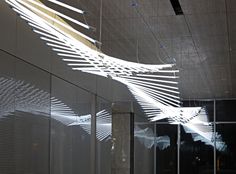 an artistic light sculpture hanging from the ceiling