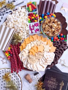 a platter filled with lots of different types of snacks and treats on top of a table