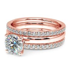 two rose gold wedding bands with a round diamond in the center and side stones on each band