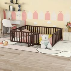 a baby's room with a teddy bear in the crib and pink walls