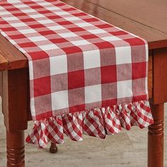 a red and white checkered table cloth on a wooden table