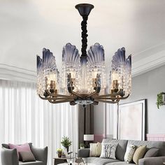 a chandelier hanging from the ceiling in a living room