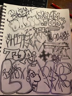 a notebook with some graffiti written on it