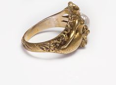 Art Nouveau Gold Mermaid Fresh Water Pearl Ring.Nowadays, rings come in a variety of interesting designs and high-quality materials, some of which are adorned with precious and semiprecious stones. And when it comes to the vintage and antique ones, you definitely have many exquisite models to explore. Please view our collection of rings. Antique Vintage Rings Art Nouveau Yellow Gold Ring, Art Nouveau Gold Ring Jewelry, Art Nouveau Gold Ring, Fresh Water Pearl Ring, Mermaid Pearl, Art Nouveau Weddings, Art Nouveau Ring, Mermaid Design, Rings Antique