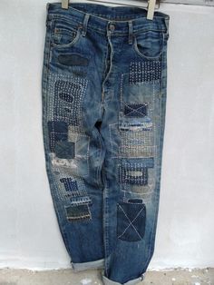 an old pair of jeans with patches on them