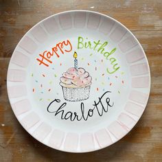 a happy birthday plate with a cupcake and candle on the front saying, happy birthday charlotte