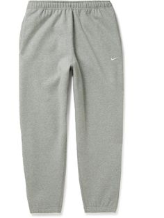 Find NIKE Tapered Cotton-blend Jersey Sweatpants Xs on Editorialist. Nike's sweatpants are designed for everyday comfort and versatility. Updated with zipped pockets, they're cut for a neat taper from fleece-back cotton-blend jersey and have an elasticated drawstring waistband. Note the solo 'Swoosh' embroidered at the leg. Gray Nike Sweatpants, Sweatpants Nike, Gray Sweatpants, Nike Sweatpants, Grey Sweatpants, Grey Nikes, Mens Activewear, Drawstring Waistband, Men's Nike