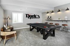 a game room with ping pong tables and bar stools