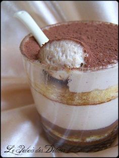 an ice cream dessert in a glass with a spoon