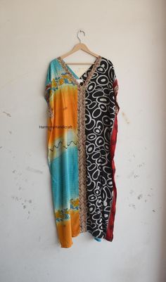 This Kaftan dress Is made From Vintage Silk Sari, Each Sari is Unique And Different. You Cannot Find The Same another one. We Collect The Saree's From Different Villages Of India And Do Customization. These are made with vintage Saree or recycled fabric, So there may be some imperfections Also in that piece you can fine the multi colors spots Dirtiness Al tough when I make these need cut out the imperfect part apart and try to give best part of Saree fabric which is making this totally different Multicolor Bohemian Maxi Dress For Navratri, Bohemian Eid Beach Kimono, Bohemian Long Kaftan For Navratri, Bohemian Beach Kimono For Eid, Multicolor Long Bohemian Tunic, Bohemian Kimono For Beach And Eid, Bohemian Kimono For Beach On Eid, Bohemian Silk Dress For Navratri, Flowy Bohemian Kaftan For Festive Occasions