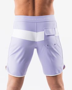 HIGHLIGHTS.. Unlined boardshort. 9” inseam Reflective branding at leg opening and back waistband Elastic waistband with adjustable self-tie drawcords Color-blocking panelling Water resistant fabric FIT SUGGESTION. This item runs true to Alphalete’s standard sizing.. Fit is based off of waist size in inches.. If you are between sizes, we recommend sizing up for a relaxed fit.. Eric is 6’2”/188cm, wearing a size 32. MATERIALS AND WASHING DIRECTIONS. 67% Nylon, 23% spandex. Due to the high saturati Sporty Fitted Surfing Bottoms, Sporty Surfing Shorts With Pockets, Summer Training Bottoms With Pockets, Sporty Swimwear With Adjustable Waist And Short Shape, Sporty Swimwear With Adjustable Waist Shorts, Fitted Tie-side Bottoms For Water Sports, Sporty Swimwear With Adjustable Waist, White Moisture-wicking Surfing Shorts, White Moisture-wicking Shorts For Surfing