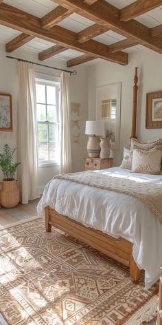 a large bed sitting in a bedroom next to a window