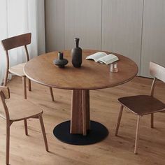 a round wooden table with two chairs around it