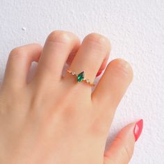 A stunning and spectacular marquis emerald design, this simple ring is the ideal option to complement any wardrobe or outfit you may have been considering. Embedded with six gorgeous natural crystals and a .75-carat, ravishing center stone, it's a design that's ideal for any occasion.  ✦ DETAILS ✦ ✧ Handcrafted  ✧ 0.75 Carat center stone ✧ Sizes 3.75-12.25 US ✧ This ring will arrive ready to gift in a Kherish Jewelry Pouch. ✧ PRE-ORDER: Items that are preorder only will ship within 10-15 busines Marquise Emerald Ring For Promise In May, Emerald Marquise Promise Ring For May Birthstone, Green Marquise Diamond Promise Ring, Marquise Emerald Ring For May Birthstone, Fine Jewelry Marquise Emerald Promise Ring, Marquise Emerald Ring For May Birthstone Gift, Green Marquise Cut Emerald Promise Ring, Marquise Cut Emerald Ring For Promise, May Birthstone, Green Marquise Birthstone Ring