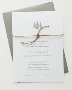 the wedding stationery is tied up with twine