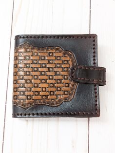 This classic styled tooled leather wallet has a dotted basket-weave pattern in coffee brown centered in a dark brown background. Brown hand stitched construction. Chrome plated snap on the strap closure adds security. Dark brown mission grain leather interior. One pocket with a window for your ID and 4 additional credit card pockets. Long pocket for bills and a change pocket with chrome plated clasp closure. This one has semi finished edges that are dyed and smooth but do show layering of the le Vintage Brown Wallets With Leather Lining, Vintage Brown Wallet With Leather Lining, Brown Embossed Wallets For Daily Use, Brown Embossed Wallet For Daily Use, Brown Embossed Leather Wallet, Brown Leather Wallet With Leather Lining, Brown Embossed Wallet, Distressed Brown Leather Wallet, Brown Artisan Wallet With Coin Pocket