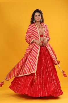 Red gota patti embroidered set featuring silk dupatta set. It comes with a beautiful striped multicolor embroidered dupatta & tassel attached. Pair it with beautiful jewelry to enhance your look. Shop online from Pure Elegance. Disclaimer: The actual product may vary slightly from the image. These are custom orders, hence expect slight variation in color, placement of the motif, or buta. ESTIMATED DELIVERYBecause this is a custom order, it would take about 4 weeks from the date of purchase. RETU Beautiful Lehenga, Fashion Journals, Pure Elegance, Embroidered Dupatta, Dupatta Set, Traditional Fabric, Silk Dupatta, Blouse Dress, Lehenga